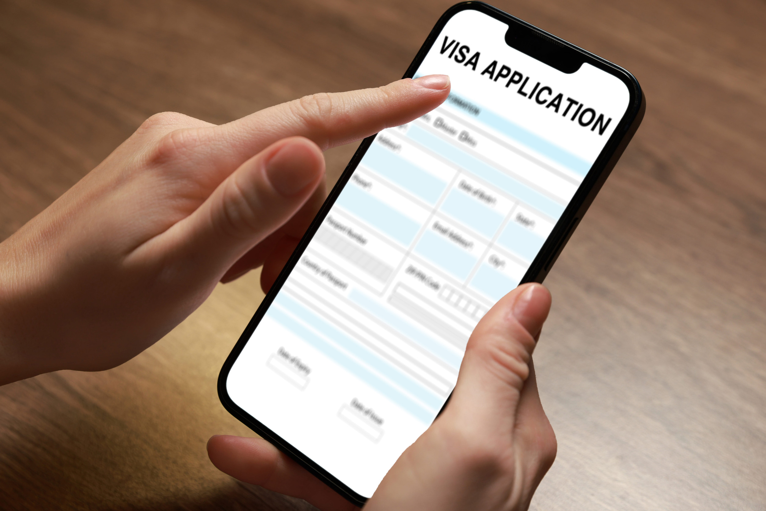A Woman Using A Phone For The Online Visa Application