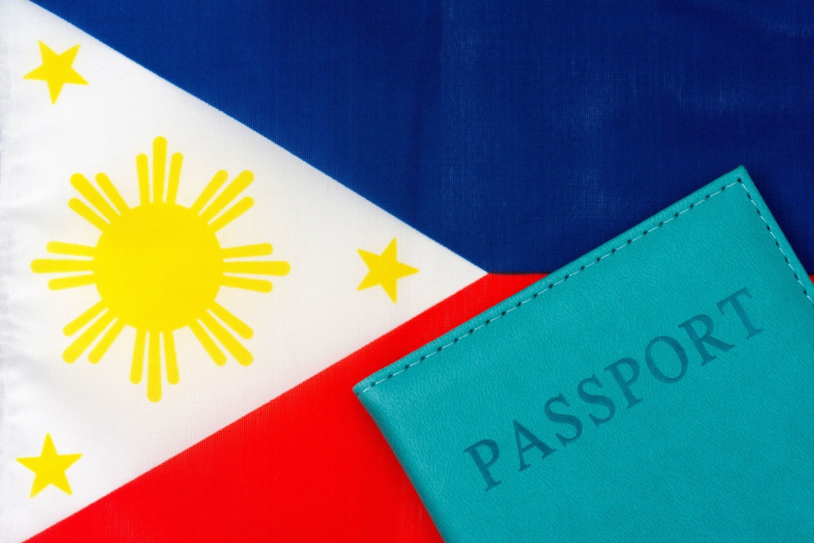 Against the background of the flag of the Philippines is a passport Against the background of the flag of the Philippines is a passport