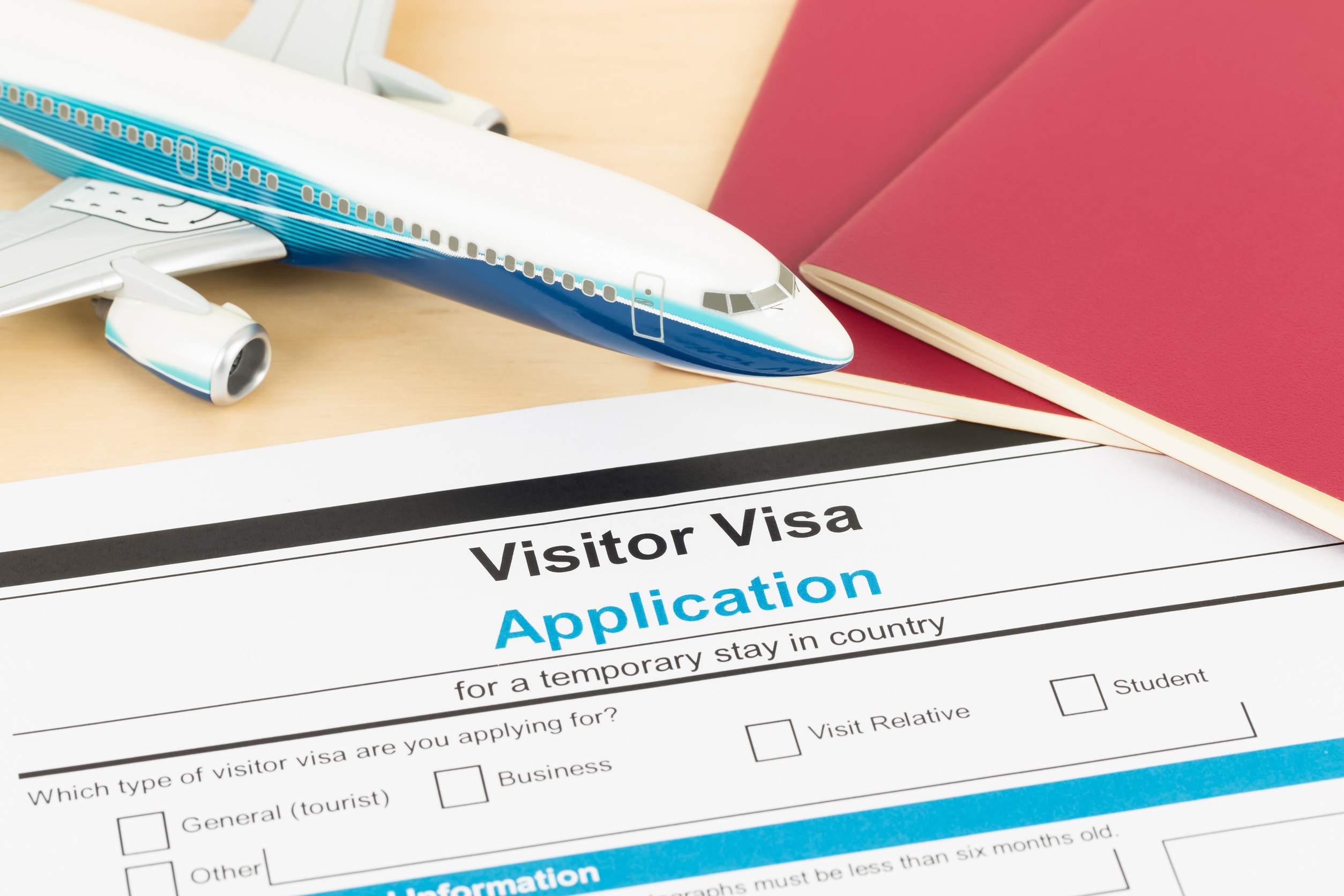 Visa Application Form With Red Passport And Plane Document Is Mock Up
